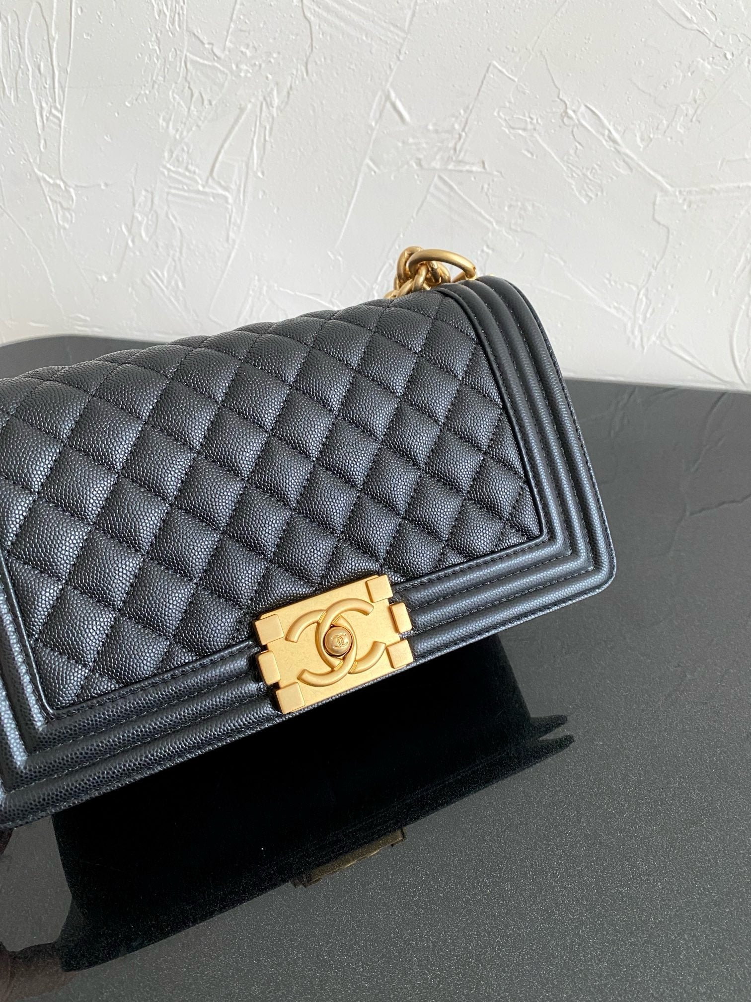 front of black boy chanel handbag gold hardware