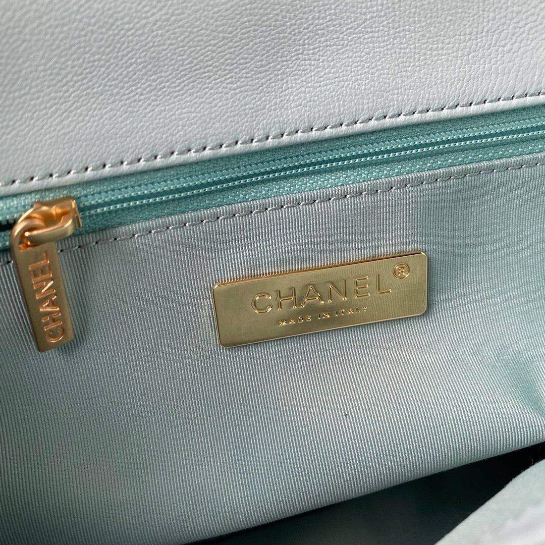 Inside gold hardware logo of chanel 19 handbag in aqua colour