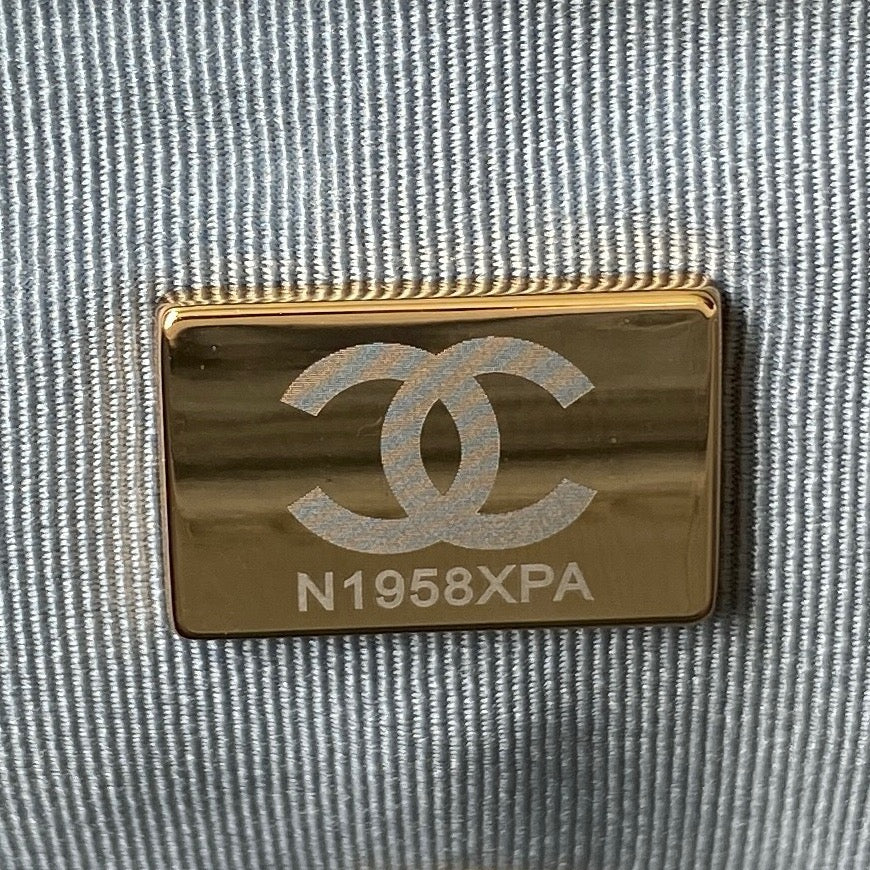 close up of microchip gold hardware of chanel 19 handbag