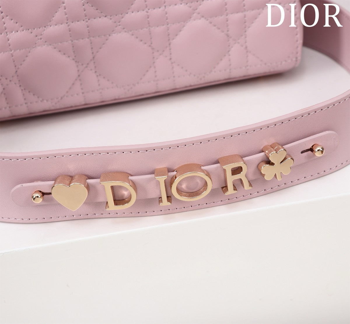 light gold hardware of pink lamb skin lady dior bag