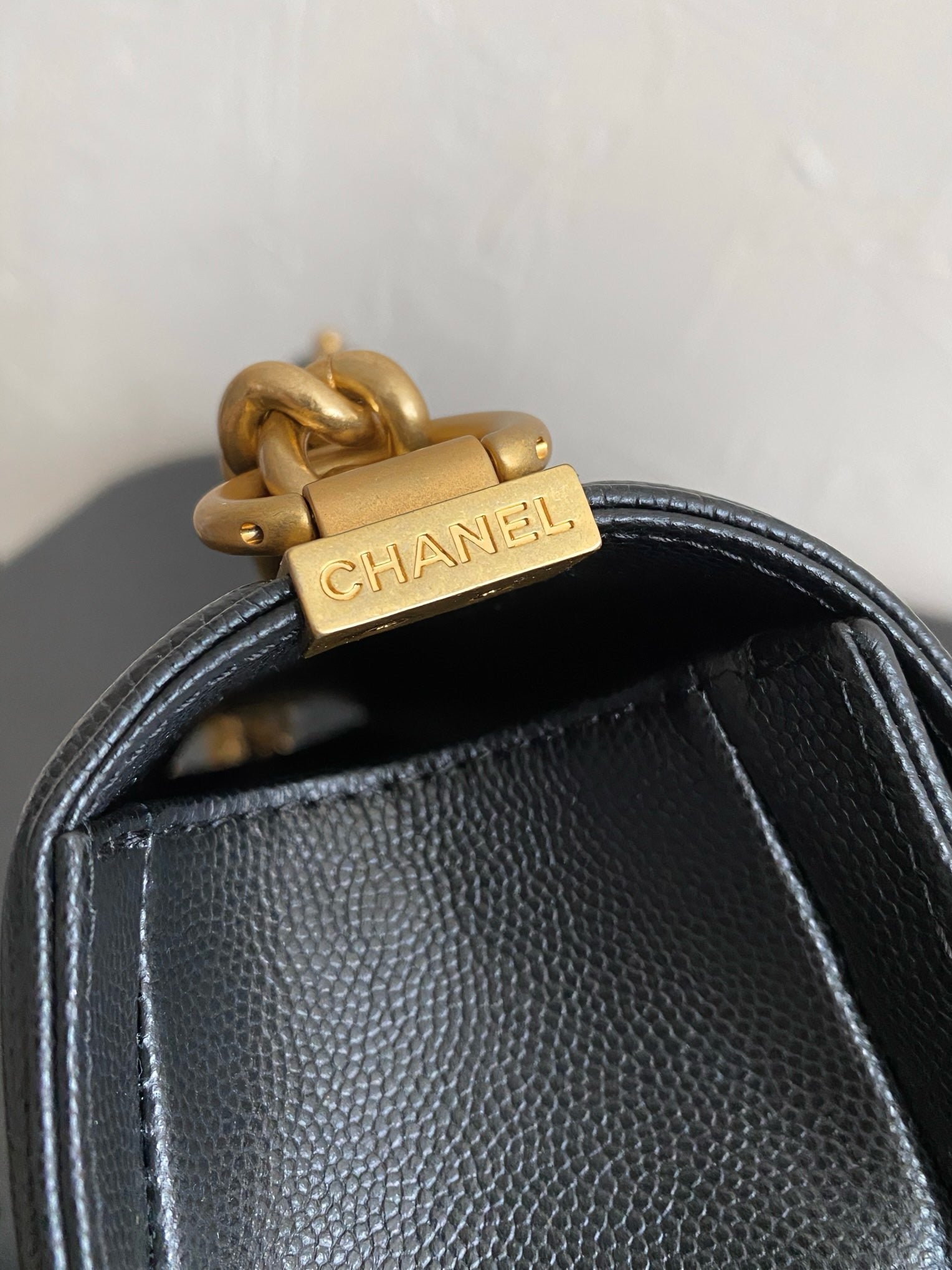 Gold hardware of black boy chanel handbag